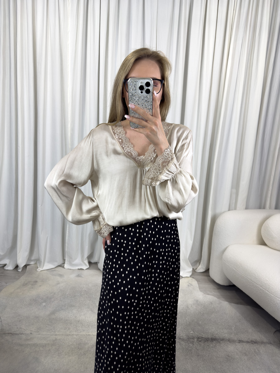 Bluzka satynowa Chic złota z dekoltem w literę V ozdobionym koronką, zestawiona ze spódnicą w groszki – elegancka i kobieca stylizacja.