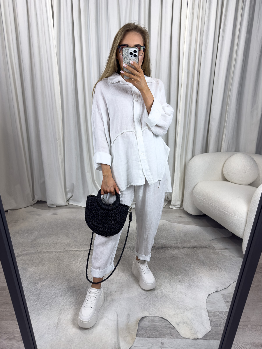 Biała lniana koszula Lori od Wiya to przewiewny model w stylu oversize. Naturalny len, eleganckie przeszycie i komfortowy krój. Stylizacja z białymi, lnianymi spodniami.